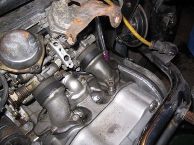 Unbolting the intake pipes from the head.
Keywords: gl1200;goldwing;1984