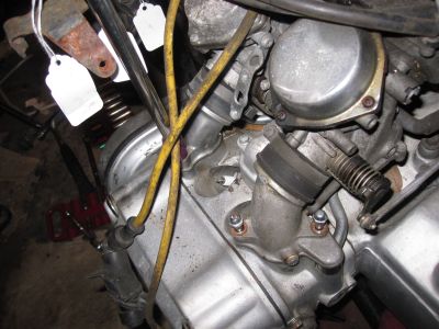 Unbolting the intake pipes from the head.
Keywords: gl1200;goldwing;1984